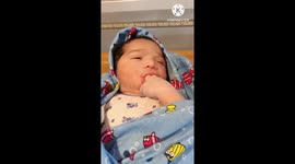Baby  boy lis sucking his fingers..due to hungry.. seeking brestmilk .. Should give him quickly to his mother...