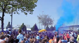 Blue smoke, chants and bananas: Man City fans welcome champion team bus home