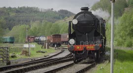 A steam train approaching level crossing on North York Moors Railway