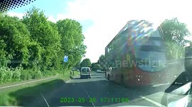 Cyclist doing wheelie wrong direction through traffic lights