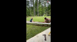 Little girl is daddy's best helper when it comes to digging trenches for gutters