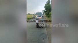Army of ducks waddle across road as drivers stop in traffic jam