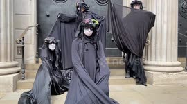 Black-robed protesters stage protest outside Bank of England
