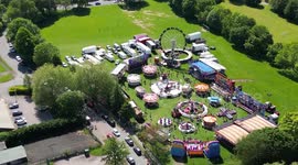Landscape drone view of a fairground that travels round the UK