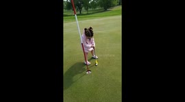 Girl Struggles to Putt