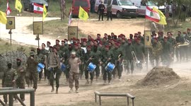 Lebanese Hezbollah fighters parade during a press tour in the southern Lebanese village of Aaramta, ahead of the anniversary of the Israeli withdrawal from Lebanon