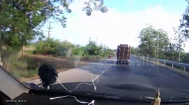 Wooden board flies off back of moving truck and hits car behind