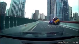 Road rage incident results in vehicle hanging off overpass in eastern China