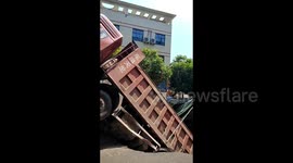 Dramatic moment sinkhole opens and swallows truck in southern China
