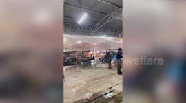 Torrential rain drenches locals as storm tears through market in Thailand