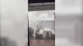 Roaring storm blows large tree branches onto cars in Thailand