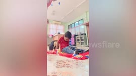 Little boy nods back and forth trying to fight off sleep at school