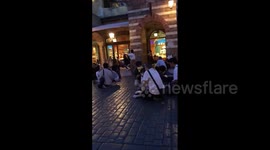 Guests at Tokyo Disneyland squat outside in open areas for safety after earthquake jolts eastern Japan