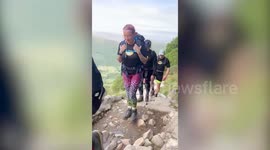 Parents carry their 10-year-old son with rare eye disease up Ben Nevis