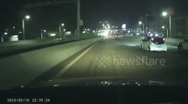 Speeding car evades collision as it squeezes between cars flipping onto two wheels in China