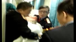 People help pregnant woman give birth on train