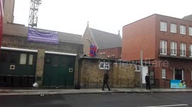 Protesters in superhero costumes scale London mosque roof