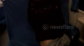 Drunk man taking off trousers on train explains that he dreams of his wife washing clothes