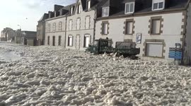 Masses of sea foam after storm in Brittany, France