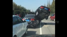 Car ends up on top of another car during major accident