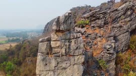 Superstitious locals admire 'Buddha palm' rock formation sitting on Thai mountain