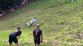 Hundreds of participants hurl themself down Cooper’s Hill for Cheese-rolling event