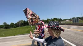A group of “American Patriots” Trump Supporters wave flags to cars driving by on Memorial Day weekend 2