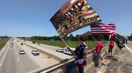 A group of “American Patriots” Trump Supporters wave flags to cars driving by on Memorial Day weekend 1