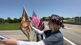 Trump supporters wave flags to cars driving by on Memorial Day weekend in Springfield, Missouri