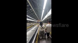 Woman narrowly avoids serious injuries after accidentally tumbles down China's longest escalator