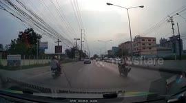 Distracted motorcycle rider bumps into pick-up truck as she fidgets on phone while driving