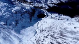Toma aérea de la laguna verde entre el volcán Iliniza Norte y Sur con drone en un día nevado
