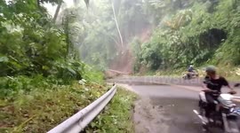 Landslide on mountain road sends motorcycle riders scrambling for safety