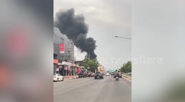 Panic as huge fire tears through wooden house next to highway in Thailand