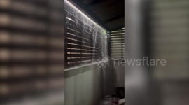 Rain pours into home during monsoon season storm in Thailand