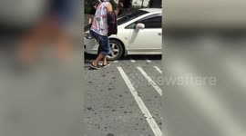 Kind pedestrians help driver rescue kitten stuck under car