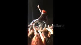 Unity is strength! Wheelchair-bound music lover surfed along top of crowd