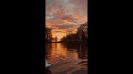 Fiery sunset covers the sky in red and gold with a tease of natures most beautiful sites