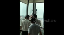 Brave office staff rescue high-rise worker hanging outside 34th-floor window in China