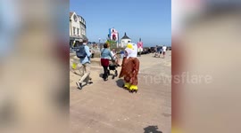 Seaside chippy worker scares off seagulls in an eagle outfit - so customers can eat their food in peace