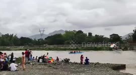 Hundreds of passengers stranded after overflowing river sumberges road