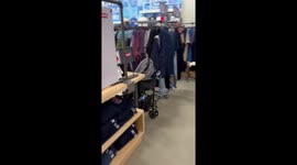 Little girl runs around the mall, dragging her stroller behind her
