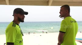 Palestinian lifeguards watch over bathers on the beach during the summer holiday, in Gaza city