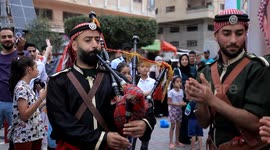 Palestinians in Gaza attend a festival marking the grand royal wedding of Jordan's Crown Prince Hussein and princess Saudi Rajwa Al Saif