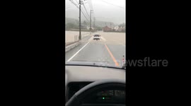Tropical Storm Mawar: Residents of Tokushima, Japan, drive through floodwater