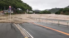 River overflows onto road in Kainan, Japan, as Tropical Storm Mawar hits country