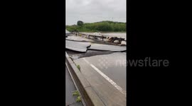 Japan: Road Collapses, Vehicles Drives Through Flooded Road In Aichi