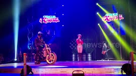 Elderly woman celebrates turning 100 by being driven at by motorbike stunt riders on stage at extreme circus
