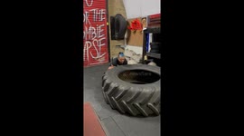 45 year old woman is training for their first strongman competition at Commando Temple gym in Deptford South London. Flipping a 150kg tyre for the first time