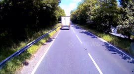 Motorcyclist forced off-road as truck makes abrupt lane change on UK highway
